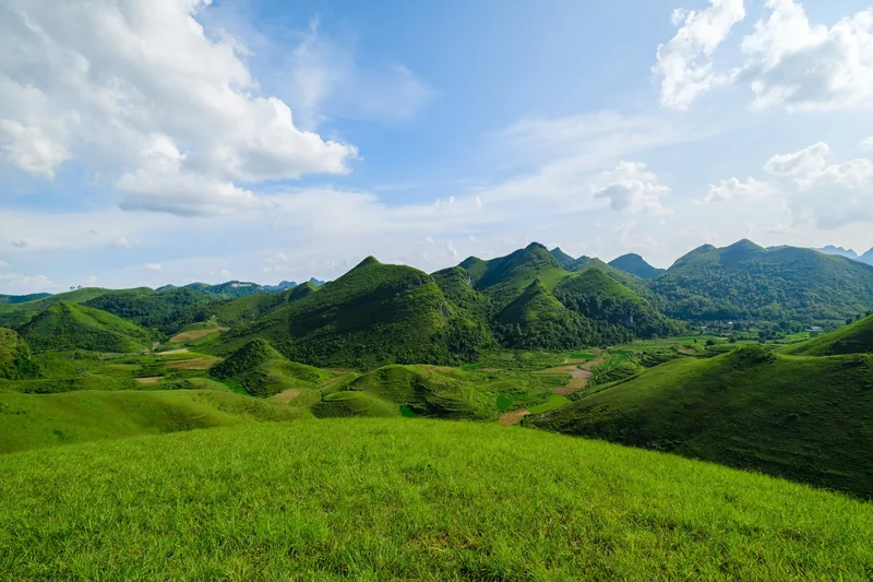Rolling green mountains and valleys under a blue sky in Cao Bang province.